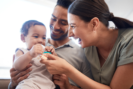 happy couple playing with a child