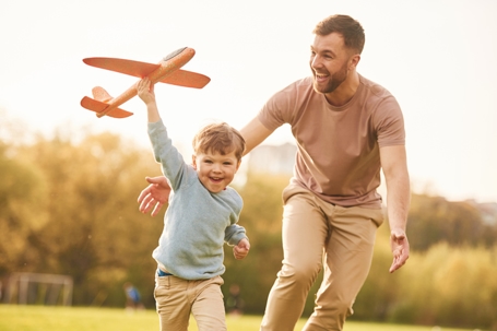 father and son playing in the park