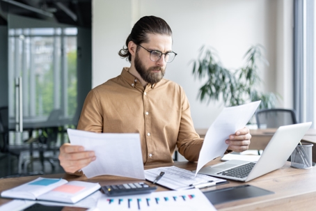 man reviewing documents at home